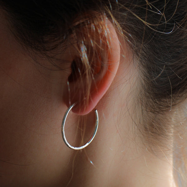 large hoop earring on model