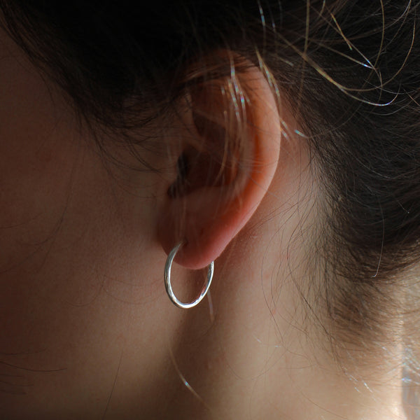 medium  hoop earring on model