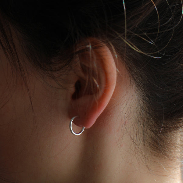 small  hoop earring on model